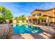 Beautiful backyard pool with stone accents and a covered patio, perfect for outdoor entertaining at 4822 E Charleston Ave, Scottsdale, AZ 85254