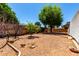 An attractive gravel backyard with mature landscaping is bordered by a decorative brick wall at 5055 E Enid Ave, Mesa, AZ 85206