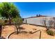 Backyard features a gravel landscape, mature trees, and partially covered patio at 5055 E Enid Ave, Mesa, AZ 85206
