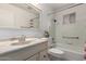 Bathroom with single sink vanity, large mirror, and tub with shower at 5055 E Enid Ave, Mesa, AZ 85206