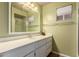 Bathroom with a single sink vanity, a large mirror, and a shower with glass doors at 5055 E Enid Ave, Mesa, AZ 85206