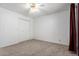Bedroom with neutral carpet, ceiling fan, and a double door closet at 5055 E Enid Ave, Mesa, AZ 85206