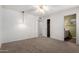 Bedroom with neutral carpet, ceiling fan, and an ensuite bathroom at 5055 E Enid Ave, Mesa, AZ 85206