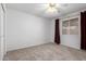 Bedroom with neutral carpet, ceiling fan, and a window letting in lots of natural light at 5055 E Enid Ave, Mesa, AZ 85206