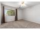 Bedroom with neutral carpet, ceiling fan, and a large window letting in lots of natural light at 5055 E Enid Ave, Mesa, AZ 85206