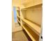 Walk-in closet featuring built-in shelving and a mirror for added convenience at 5055 E Enid Ave, Mesa, AZ 85206