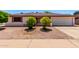 Home featuring desert landscaping, a two car garage, and mature trees at 5055 E Enid Ave, Mesa, AZ 85206