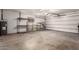 Garage features a white door, shelving units, concrete flooring, and plenty of storage space at 5055 E Enid Ave, Mesa, AZ 85206