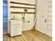 Functional laundry room with ample shelving, a utility sink, and vinyl floors at 5055 E Enid Ave, Mesa, AZ 85206