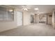 This is a carpeted sun room with white brick walls, multiple windows, ceiling fans, and sliding glass doors at 5055 E Enid Ave, Mesa, AZ 85206