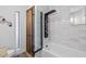 Modern bathroom with designer shower, wood look floor tiles, and custom storage at 526 W Kings Ave, Phoenix, AZ 85023