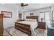 Spacious bedroom featuring a ceiling fan, wood flooring, and ensuite bathroom access, offering a relaxing retreat at 526 W Kings Ave, Phoenix, AZ 85023