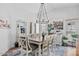 Bright dining room boasts a vaulted ceiling, chandelier, and ample seating, perfect for gathering and entertaining at 526 W Kings Ave, Phoenix, AZ 85023