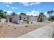 Charming single-story home featuring a two-car garage, neutral stucco, rock landscaping, and palm trees at 526 W Kings Ave, Phoenix, AZ 85023
