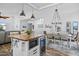 Modern kitchen and dining area featuring wood floors, pendant lighting, a wine refrigerator, and stainless steel appliances at 526 W Kings Ave, Phoenix, AZ 85023