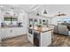 Open kitchen and living area featuring wood floors, pendant lighting, a wine refrigerator, and stainless steel appliances at 526 W Kings Ave, Phoenix, AZ 85023