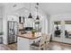 Modern kitchen featuring wood floors, pendant lighting, a wood top kitchen island, and stainless steel appliances at 526 W Kings Ave, Phoenix, AZ 85023