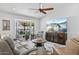 Open living area featuring wood floors, vaulted ceilings, a large TV, and natural light from the bay window at 526 W Kings Ave, Phoenix, AZ 85023