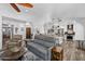Living area featuring wood floors, vaulted ceilings, an entertainment center, and an open floor plan to the kitchen at 526 W Kings Ave, Phoenix, AZ 85023