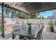 Outdoor patio with table, chairs, and shaded pergola, ideal for enjoying outdoor living and entertaining at 526 W Kings Ave, Phoenix, AZ 85023