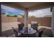 Covered patio with a table and chairs and a BBQ in the large backyard at 5726 W Atlantis Way, Phoenix, AZ 85043