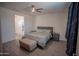 Cozy bedroom featuring a queen bed, a ceiling fan, and wood-look tile flooring at 5726 W Atlantis Way, Phoenix, AZ 85043