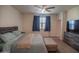 Bright bedroom with a queen bed and a window with blue curtains at 5726 W Atlantis Way, Phoenix, AZ 85043