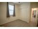 This bedroom features wood-look flooring, a window with gray curtains, and a large closet at 5726 W Atlantis Way, Phoenix, AZ 85043