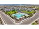 Aerial view of community pool, playground, and green space featuring views of the surrounding neighborhood at 5726 W Atlantis Way, Phoenix, AZ 85043