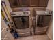 Modern laundry room featuring a gray washer and dryer with wood cabinets above at 5726 W Atlantis Way, Phoenix, AZ 85043