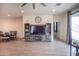 Open living room featuring wood floors, ceiling fan, and a sliding glass door at 5726 W Atlantis Way, Phoenix, AZ 85043