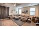 Comfortable living room with a large sectional sofa, area rug, and ample natural light at 5726 W Atlantis Way, Phoenix, AZ 85043