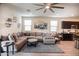 Cozy living room with large sectional sofa, ceiling fan, and natural lighting, perfect for relaxation at 5726 W Atlantis Way, Phoenix, AZ 85043