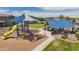 Community playground featuring a play structure, picnic tables, and mature landscaping at 5726 W Atlantis Way, Phoenix, AZ 85043