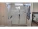 Bright shower with glass enclosure, seat, and a view into the Primary bedroom at 5726 W Atlantis Way, Phoenix, AZ 85043