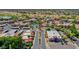 Aerial view of the community with multiple buildings, palm trees, pool, and a roundabout at 5757 W Eugie Ave # 1076, Glendale, AZ 85304