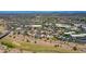 Wide aerial view of a neighborhood with tidy red-roofed homes, nestled near commercial areas and a vast desert landscape at 5757 W Eugie Ave # 1076, Glendale, AZ 85304