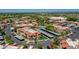 This aerial shows a community with covered parking, landscaped grounds, and multiple condo buildings at 5757 W Eugie Ave # 1076, Glendale, AZ 85304