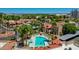 Aerial view of the community pool offers a refreshing escape with lounge chairs and lush palm trees at 5757 W Eugie Ave # 1076, Glendale, AZ 85304