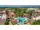 This aerial showcases a community pool, palm trees, and condo exteriors in a picturesque setting at 5757 W Eugie Ave # 1076, Glendale, AZ 85304