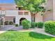Charming two-story condo with lush landscaping, mature trees, and inviting entry at 5757 W Eugie Ave # 1076, Glendale, AZ 85304