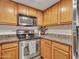 Kitchen showcases stainless steel appliances, granite countertops, and wooden cabinets at 5757 W Eugie Ave # 1076, Glendale, AZ 85304