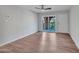 Bright living room featuring sleek wood floors and a sliding glass door to the cozy porch at 5757 W Eugie Ave # 1076, Glendale, AZ 85304
