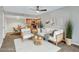 Bright living room features a ceiling fan, modern furnishings, and an open layout to the kitchen at 5757 W Eugie Ave # 1076, Glendale, AZ 85304