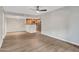 Spacious open-concept living room with wood floors, access to the kitchen, and lots of natural light at 5757 W Eugie Ave # 1076, Glendale, AZ 85304