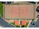 Aerial view of the community tennis court with red roofing on a shade structure and surrounding landscaping at 5757 W Eugie Ave # 1076, Glendale, AZ 85304