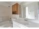 A clean bathroom features tile surround, a sink, and a large mirror at 6611 W Kingston Ln, Glendale, AZ 85306