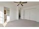 A bright bedroom featuring neutral carpet and closet space at 6611 W Kingston Ln, Glendale, AZ 85306