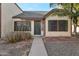 Charming front entrance with tidy landscaping and dark green door at 6611 W Kingston Ln, Glendale, AZ 85306