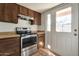 Kitchen featuring stainless steel oven and wooden cabinets at 6611 W Kingston Ln, Glendale, AZ 85306